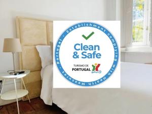a sign that says clean and safe in a bedroom at WW Hostel & Suites in Coimbra
