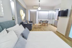 a bedroom with a large bed and a living room at Giorgio Studio in Preveza