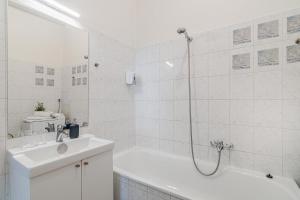 a white bathroom with a tub and a sink at APT in center Prague w Netflix by Michal&Friends in Prague