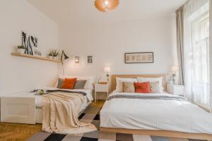 two beds in a room with white walls at APT in center Prague w Netflix by Michal&Friends in Prague