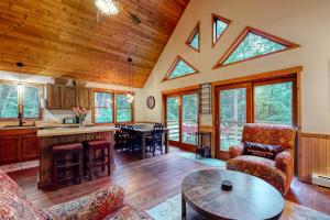 a living room with a table and a kitchen at Artist Brook Escape in North Conway