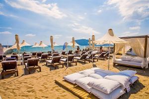 a group of chairs and umbrellas on a beach at Yaman Life Hotel in Alanya