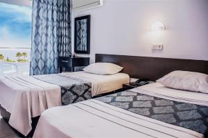 a hotel room with two beds and a window at Yaman Life Hotel in Alanya +29 photos