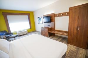 a hotel room with a bed and a tv at Holiday Inn Express Hotel & Suites Ontario, an IHG Hotel in Ontario