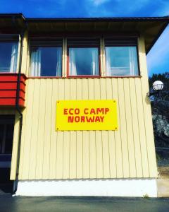 a yellow sign on the side of a building at Eco Camp Norway in Smøla