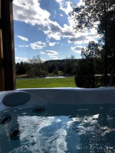 a pool of water with a view of a field at Inner Joy Getaways in Elora