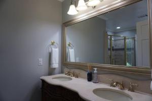 a bathroom with two sinks and a large mirror at Beautiful & large newly renovated 5 bedroom house. in Marietta +21 photos