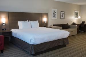 a hotel room with a bed and a chair at Country Inn & Suites by Radisson, Platteville, WI in Platteville