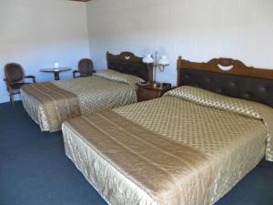 a hotel room with two beds and two nightstands at Alamo Inn in Alamo