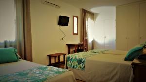 Säng eller sängar i ett rum på Hotel Ayamontino