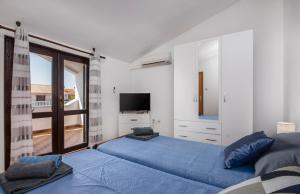 1 dormitorio con 2 camas y ventana grande en Apartment Blu, en Pula