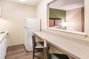 a kitchen with a counter and a refrigerator in a room at Extended Stay America Suites - Houston - Northwest - Hwy 290 - Hollister in Houston