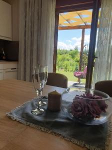 einen Tisch mit einem Teller Essen und einem Glas Wein in der Unterkunft Donna in Grabovac
