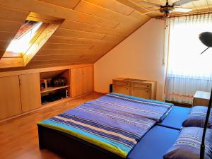 a large bed in a room with a wooden ceiling at Ferienwohnung Angelika in Bad Kissingen