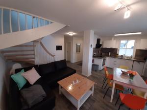 a living room with a couch and a table at Dat Papenboerger Hus in Zierow