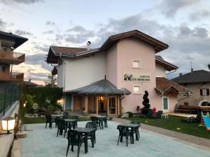 a patio with tables and chairs in front of a building at SAN ROMEDIO Agriturismo in Romeno
