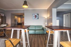 a living room with two tables and a couch at Atlantic Home Azores in Ponta Delgada