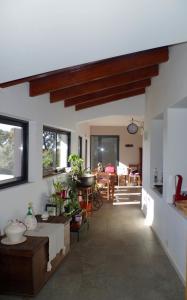 a living room with white walls and wooden ceilings at Vinha do Gaio in Monchique