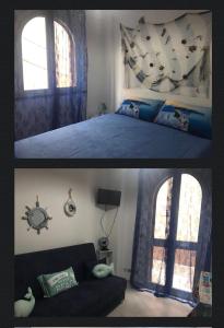 a bedroom and a living room with a bed and a couch at the goat on the beach in Scilla