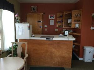 a kitchen with a counter and a refrigerator at Hillcrest Motel in Norton