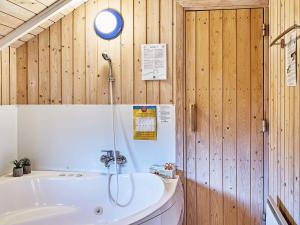 a bathroom with a tub and a sink at 6 person holiday home in Hemmet in Falen