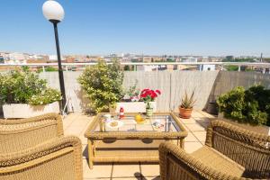 a patio with chairs and a table on a roof at Hotel Sancho in Madrid