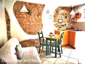ベネヴェントにあるOneiro Bed and Relaxの石壁のキッチン(テーブル、椅子付)