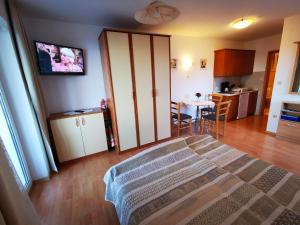 a living room with a sliding door and a kitchen at Apartments Solte in Mošćenice