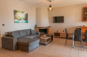 a living room with a couch and a table at John's Apartments in Karistos