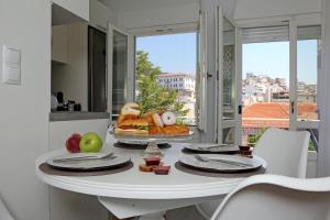 a white table with a tray of food on it at Under the Aqueduct boutique house in Kavála