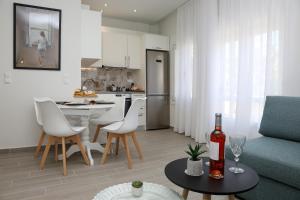 a kitchen and living room with a couch and a table at Under the Aqueduct boutique house in Kavála