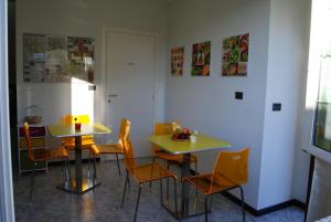 a dining room with two tables and orange chairs at B&B Villa Grace in Citta' Sant'Angelo