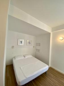 a white bedroom with a white bed in a room at Aleksi rooms in Shëngjin