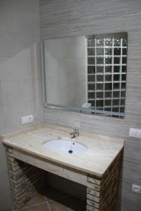 a bathroom with a sink and a mirror at CUEVAS AL ANDALUS - Solea in Orce