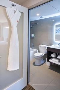 a white dress is hanging in a bathroom at Hotel Mariposa in Los Angeles