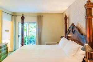 a bedroom with a large bed with a wooden headboard at The Bergson in Calistoga