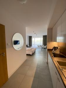 a bedroom with a bed and a mirror on the wall at Aquamarina Prima Gold in Międzyzdroje