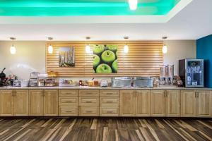 a kitchen with wooden cabinets and a counter top at La Quinta by Wyndham Grand Forks in Grand Forks