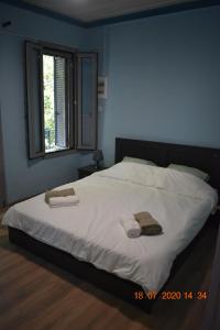 a bedroom with a large bed with two towels on it at The central house! in Raches