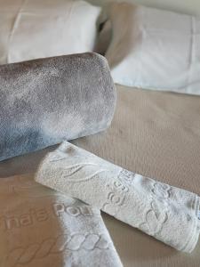 two pieces of paper and a knife on a bed at Marinas Pousada in Pasto da Mata