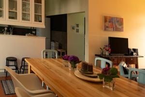 a dining room with a wooden table and chairs at Casa da Quinta in Vila Franca do Campo