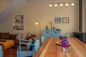 a living room with a wooden table with flowers on it at Casa da Quinta in Vila Franca do Campo