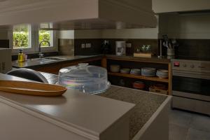 a kitchen with a sink and a counter top at Casa da Quinta in Vila Franca do Campo