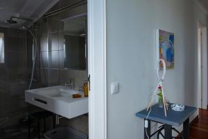 a bathroom with a white sink and a mirror at Casa da Quinta in Vila Franca do Campo