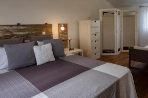 a bedroom with a large bed and a dresser at Casa da Quinta in Vila Franca do Campo