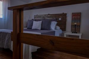 a bedroom with a bed with a large wooden frame at Casa da Quinta in Vila Franca do Campo