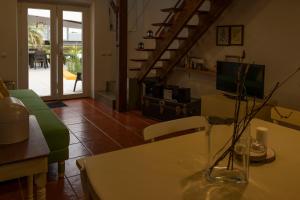 a living room with a vase on a table at Casa da Quinta in Vila Franca do Campo