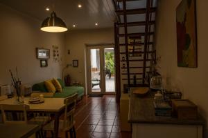 a living room with a green couch and a table at Casa da Quinta in Vila Franca do Campo