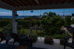 a porch with chairs and a view of the ocean at Casa da Quinta in Vila Franca do Campo