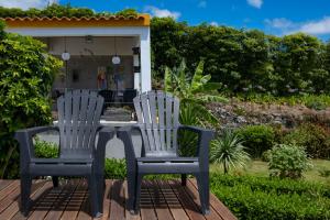 two chairs and a table on a deck at Casa da Quinta in Vila Franca do Campo